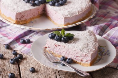 blueberry cheesecake with coconut and mint close-up. horizontal