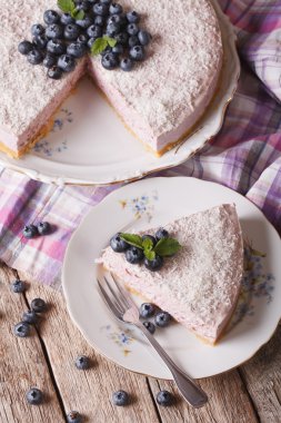 Sliced blueberry cheesecake with coconut closeup. vertical top v