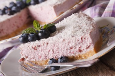 Sliced blueberry cheesecake with fresh berries macro. horizontal