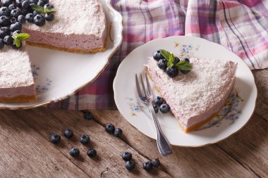 Sliced blueberry cheesecake with fresh berries close-up. horizon