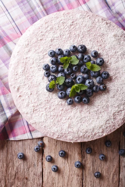 cheesecake with blueberries and mint close-up. vertical top view
