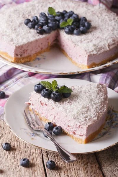Homemade blueberry cheesecake with fresh berries closeup. Vertic