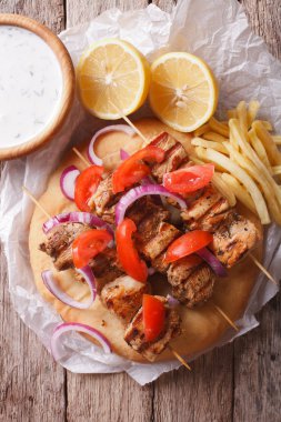 Greek souvlaki with vegetables and french fries. vertical top vi