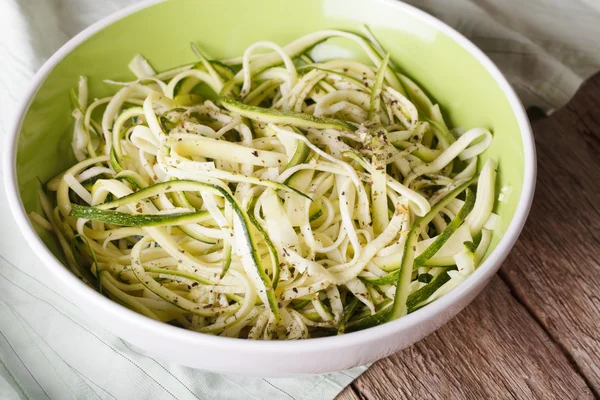 Natural food: raw zucchini pasta in a bowl closeup. horizontal — 图库照片