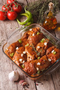 Meat in red marinade with spices, thyme, garlic and chilli in a 
