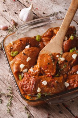 Raw meat in a spicy red marinade in a bowl close up. Vertical