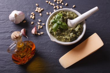 Traditional pesto sauce in a mortar and ingredients. horizontal 