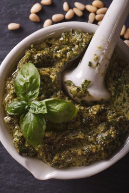 Italian pesto in a mortar macro. vertical top view