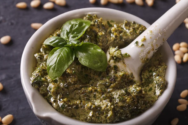 Italian pesto sauce in a mortar close-up. horizontal — Stock Photo, Image