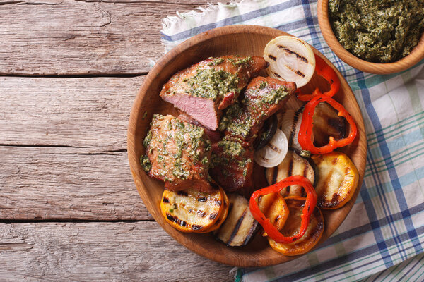 Стейк и жареные овощи с песто крупным планом. горизонтальный верх
 