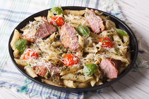 Delicious penne pasta with meat, parmesan and pesto sauce — Stock Photo, Image