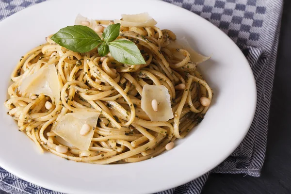 Linguine pasta with pesto sauce, pine nuts and Parmesan cheese c — Stock Photo, Image