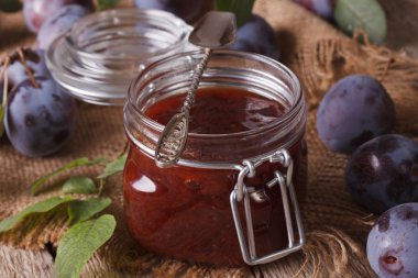 Fresh homemade plum confiture in a glass jar close-up. horizonta