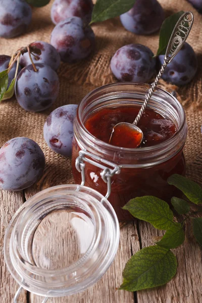 Fresh homemade plum jam in a jar on the table close-up. vertical — Stock Photo, Image