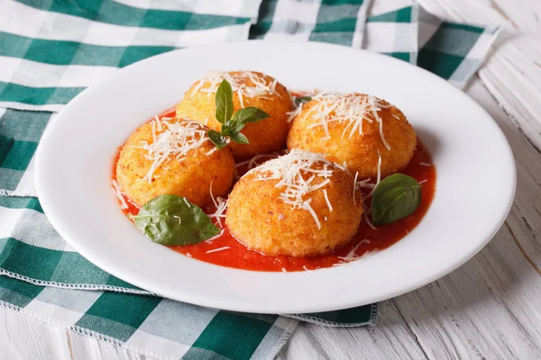 Fried arancini rice balls with tomato sauce on the table. horizo — 图库照片