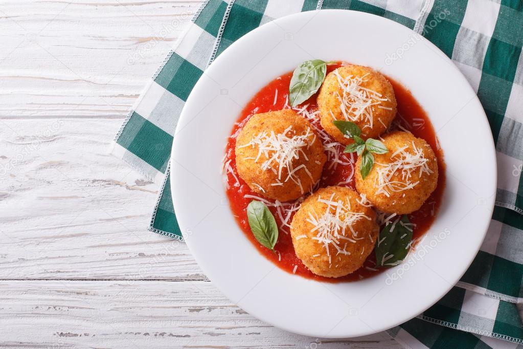 fried arancini rice balls with tomato sauce. horizontal top view