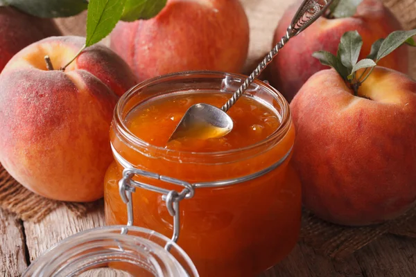 Marmellata di pesche fresche in un barattolo di vetro da vicino sul tavolo. Orizzonte — Foto Stock