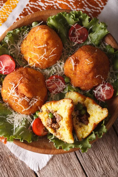 Arancini rice balls with meat close-up on a plate. vertical top — Stock Photo, Image