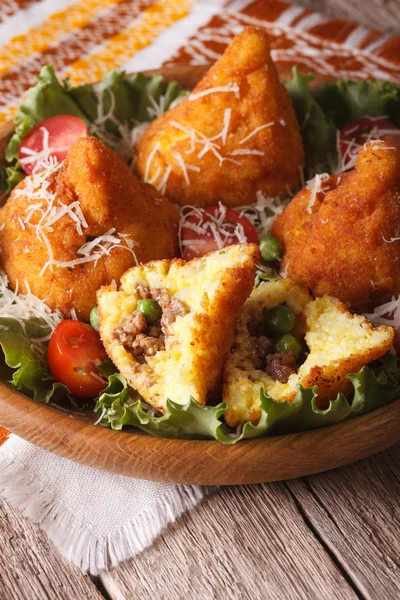 Arancini with meat and peas close-up on a plate. vertical — Stock Photo, Image