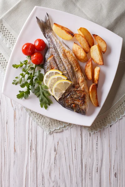 Gegrillter Dorado-Fisch mit Bratkartoffeln und Tomaten. vertikale Spitze — Stockfoto