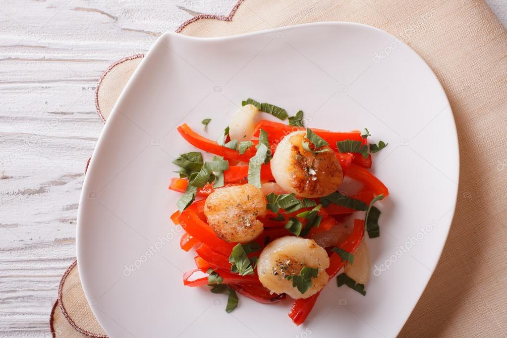 Grilled Scallops with peppers and herbs closeup. Horizontal top 