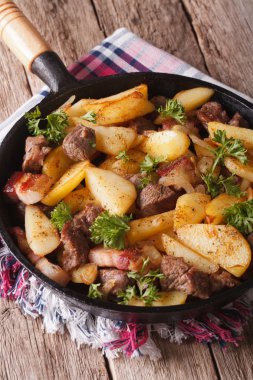 Hot country fried potatoes with meat and bacon served in a pan c