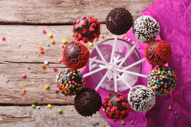Delicious colorful cake pops in a glass. Horizontal top view