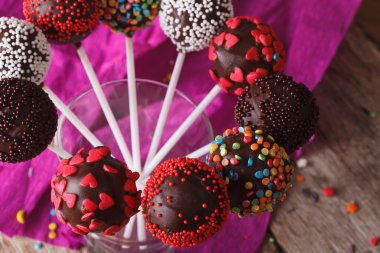 Delicious chocolate cake pops in a glass closeup. horizontal