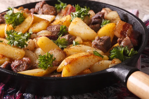 Рустикальна їжа: смажена картопля з м'ясом та беконом на сковороді крупним планом — стокове фото
