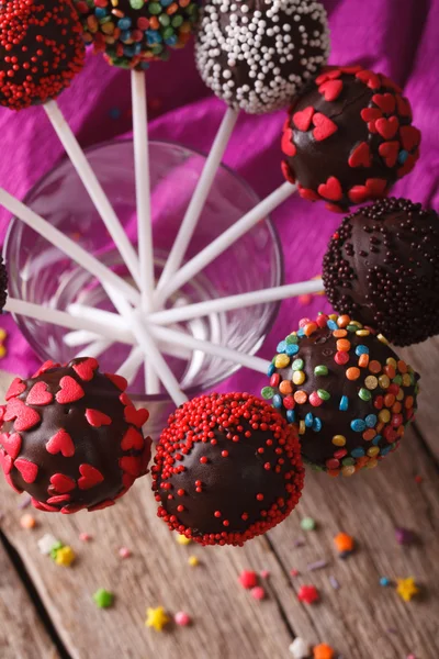 Chocolate cake pops closeup in a glass on the table. vertical to — Stock fotografie