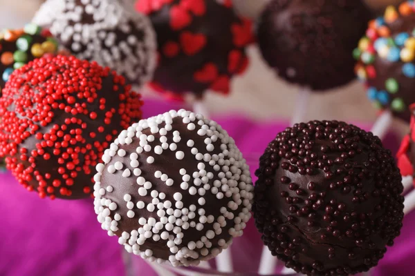 Beautiful chocolate cake pops with multicolored candy sprinkles — Stock Photo, Image