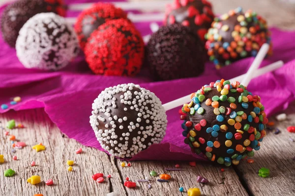 Festive chocolate cake pops with candy sprinkles close-up. horiz — Stockfoto