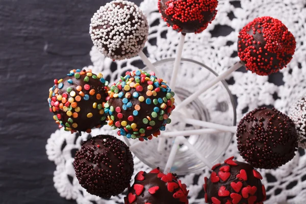 Chocolate cake pops with candy sprinkles closeup. horizontal top — Stock fotografie