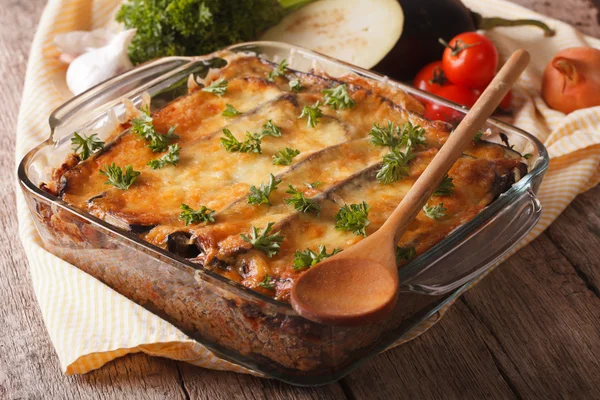 Greek moussaka closeup in baking dish and ingredients. horizonta — Stock Fotó