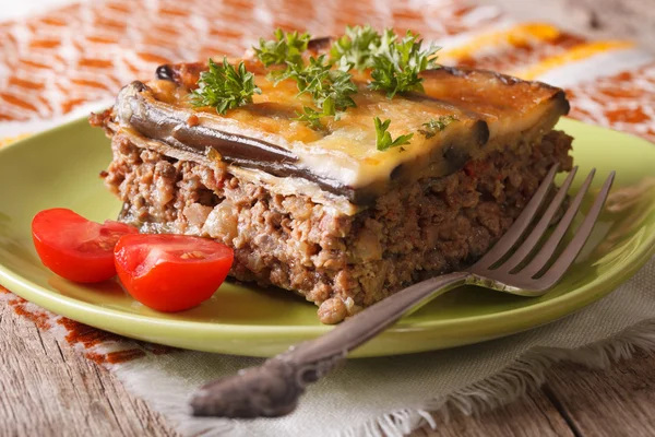 Homemade moussaka on the green plate close-up. horizontal — ストック写真