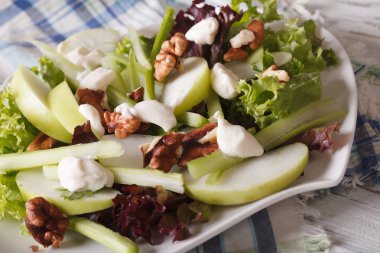 Fresh Waldorf Salad close-up on a plate on the table. horizontal