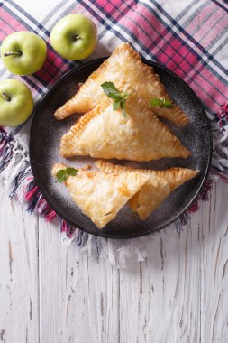 homemade apple pie turnover on a plate. vertical top view