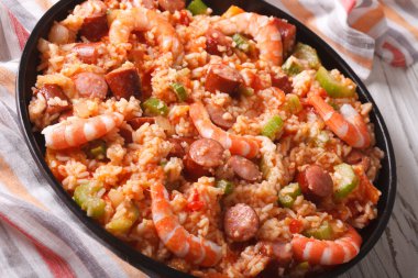 Creole food: jambalaya with shrimp and sausage close-up. horizon