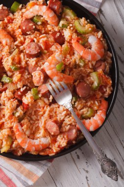 Creole cuisine: jambalaya close-up on a plate. vertical top view
