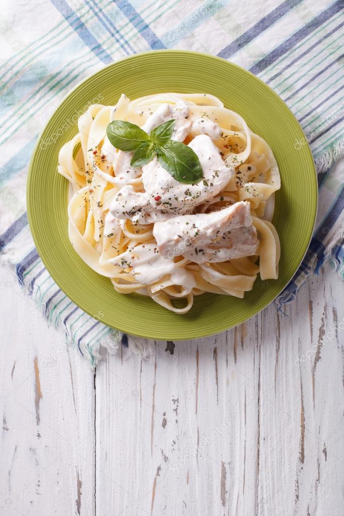 alfredo pasta in cream sauce with chicken. vertical top view