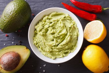 Delicious guacamole sauce close-up on the table. Horizontal top