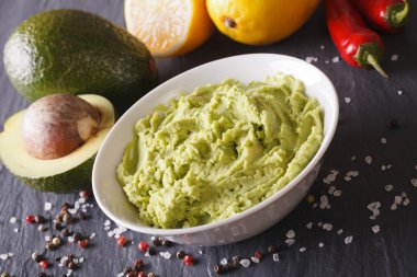 Traditional guacamole sauce with ingredients close-up. Horizonta