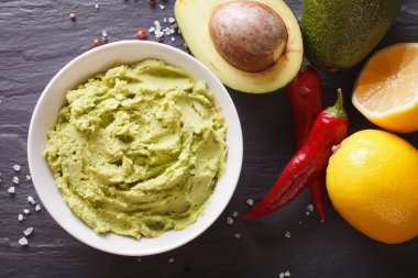 guacamole sauce with ingredients close-up. horizontal top view