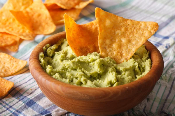 Guacamole and nachos chips close up in a wooden bowl. Horizontal — Φωτογραφία Αρχείου