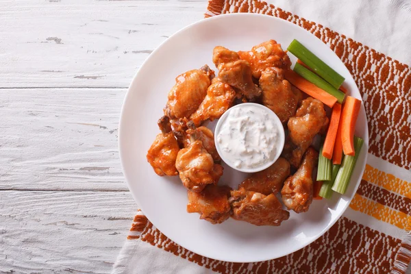 Buffalo chicken wings with sauce and celery.horizontal top view — Stock Photo, Image