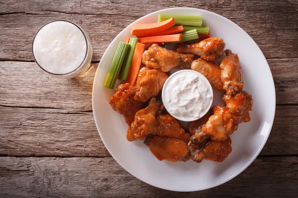 American fast food: buffalo wings and beer horizontal top view — Stock Photo, Image
