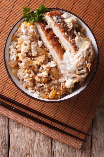 Katsudon fried pork tonkatsu with egg and rice closeup. Vertical