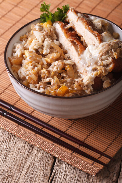 Japanese food Katsudon breaded deep fried pork on rice. Vertical