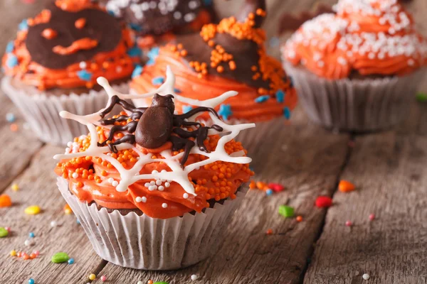 Funny colorful Halloween cupcakes on a table close-up. — Stock Photo, Image