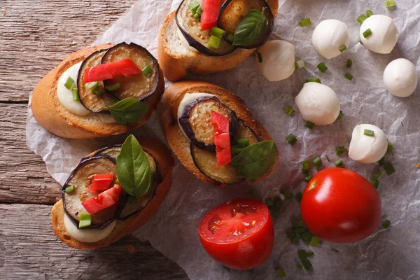 Crostini with aubergine, tomato and cheese close-up. Horizontal — Stockfoto